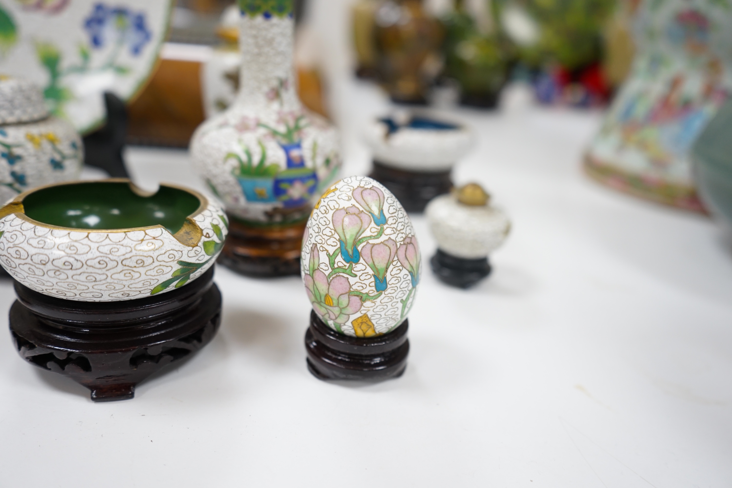 A collection of Chinese cloisonné enamel vases, pots etc., all worked on a white background in floral designs, plate, 20cm diameter. Condition - good